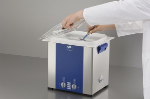 An Elma ultrasonic cleaner with an acid-resistant plastic tub insert